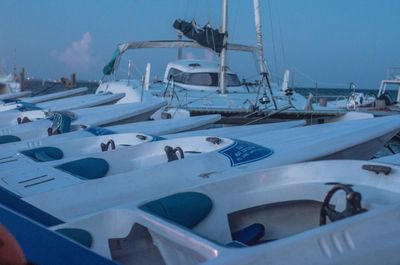 Sailboats moored at harbor during winter