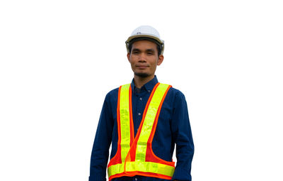 Portrait of young man standing against white background