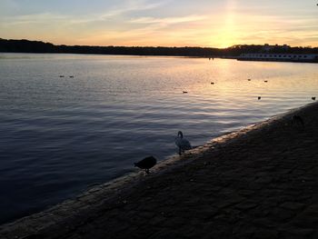 Scenic view of lake against sky during sunset