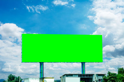 Low angle view of road sign against sky