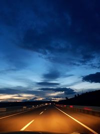 Highway against sky at night