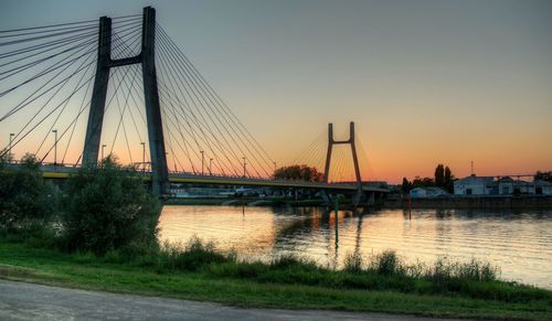 Silhouette bridge against sky during sunset