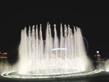 Light trails on fountain at night