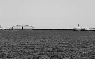 Bridge over sea against clear sky