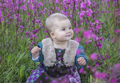 Portrait of cute girl standing amidst plants