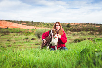 Portrait of woman with dog on field