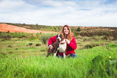 Woman with dog on field against sky