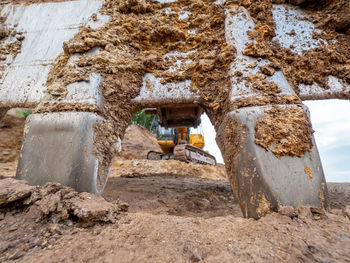 Clay crack under big excavator shovel claw. excavator digging a deep trench  in the ground