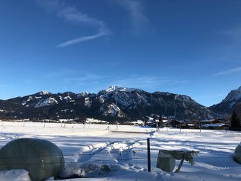 Snow covered mountains against blue sky