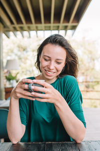 Portrait of smiling young woman using mobile phone