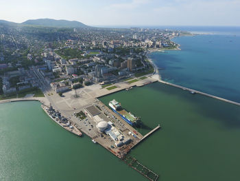 High angle view of city by sea against sky