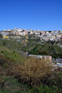 High angle view of buildings against clear sky