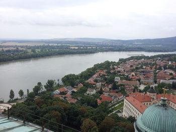 View of cityscape against cloudy sky