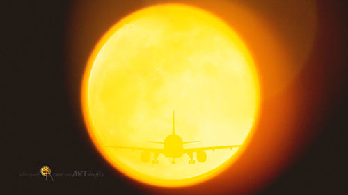 Close-up of moon against orange sky