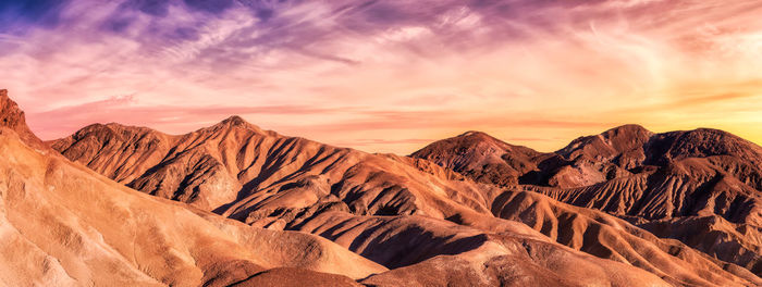 Scenic view of mountain against cloudy sky during sunset