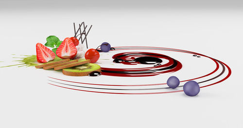 Close-up of fruits served on white background