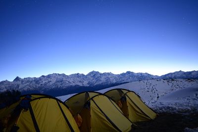 Scenic view of mountains against blue sky