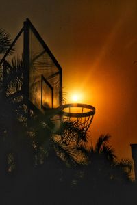 Silhouette built structure against sky during sunset