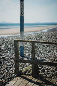 Close-up of pebbles on beach against sky