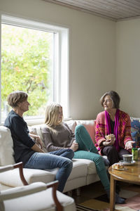 Three generation females spending leisure time in living room