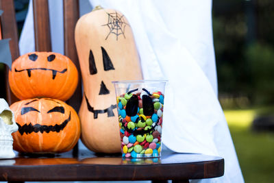 Decoration for halloween. pumpkins with creepy faces, colorful candies and sweets.