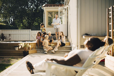 Family spending leisure time at patio during sunny day