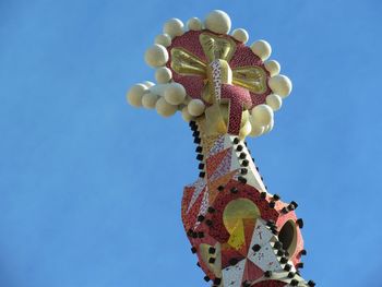 Low angle view of sculpture against clear blue sky