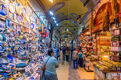 People at illuminated market stall in city