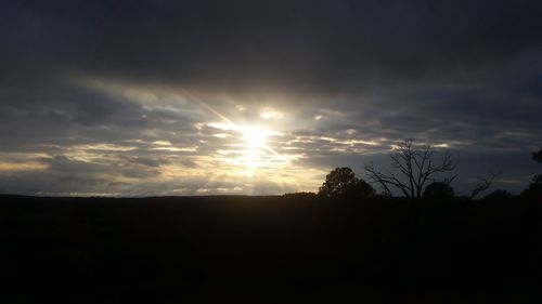 Silhouette landscape against sky during sunset