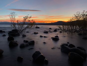 Scenic view of lake against sky during sunset