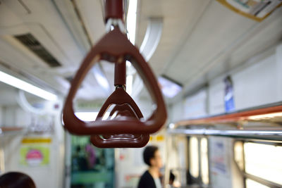 Close-up of handles hanging in train