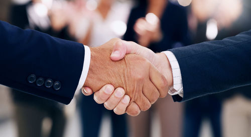 Close-up of business people shaking hands