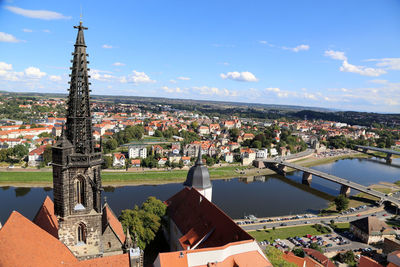 Meissen cathedral by elbe river against sky in town