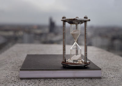 Close-up of clock on table at beach