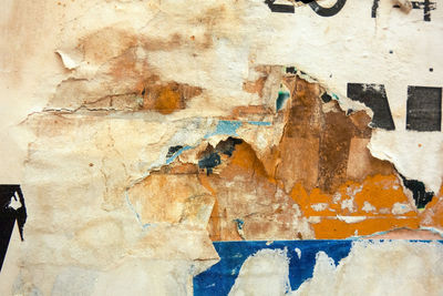 Torn posters on old wall