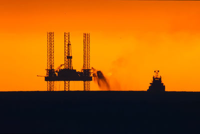 Silhouette of cranes at sunset