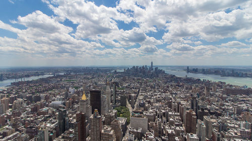 Panoramic view of sea and buildings against sky