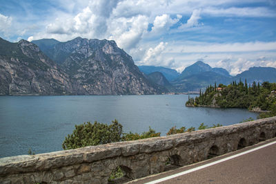 Scenic view of mountains by sea against sky at lake garda italy