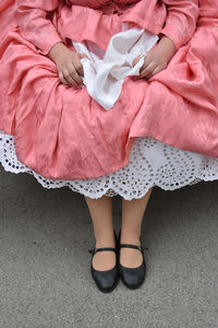 Low section of woman with pink legs on bed