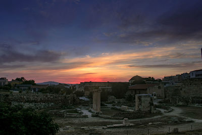 Old buildings against sky during sunset