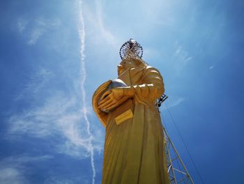 Low angle view of statue against blue sky