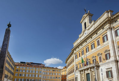 Low angle view of buildings against blue sky