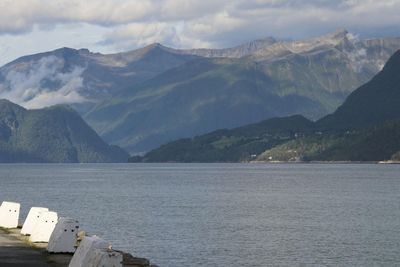 Scenic view of lake and mountains against sky