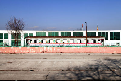 Train at railroad station against clear sky