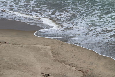 High angle view of surf on beach