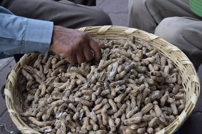 Cropped image of man buying peanut at market