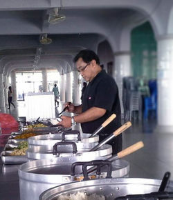 Side view of man preparing food in kitchen