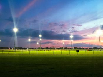 Illuminated floodlights at stadium