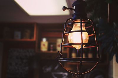 Close-up of illuminated light bulb at home