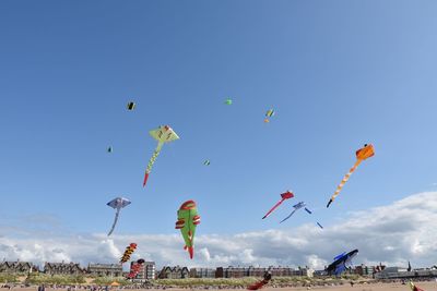 Low angle view of hot air balloons against blue sky